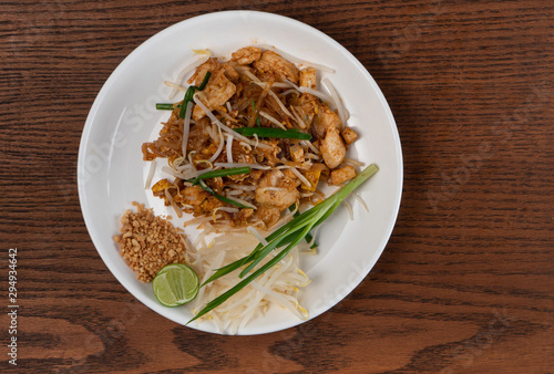 Top view Thai food Pad Thai chicken isolated on wooden table