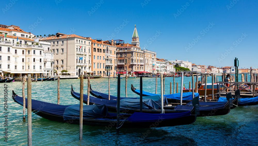 Fototapeta premium Venetian gondolas moored in Grand Canal