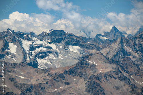 Caucasus mountains near Elbrus volcano with glaciers  clouds and peaks.