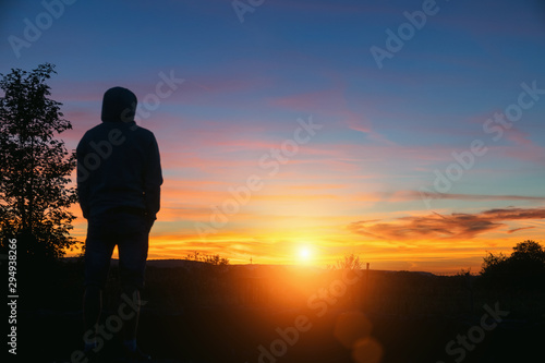 Man watching the beautiful sunset landscape