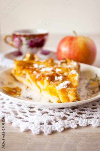 Homemade fruit apple apricot peach pie on white crochet napkin on white rustic table background