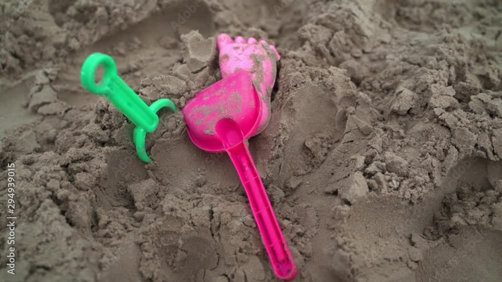 childrens toys on sand at beach in bad weather at daylight childrens toys on sand at beach in bad weather at daylight