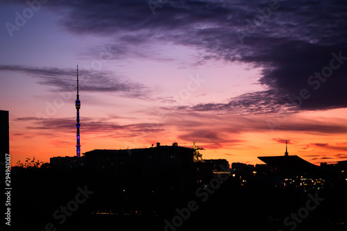 Silhouette of Moscow buildings at sunset with a statue of a worker and a collective farmer and Ostankino tower at VDNH, Moscow.