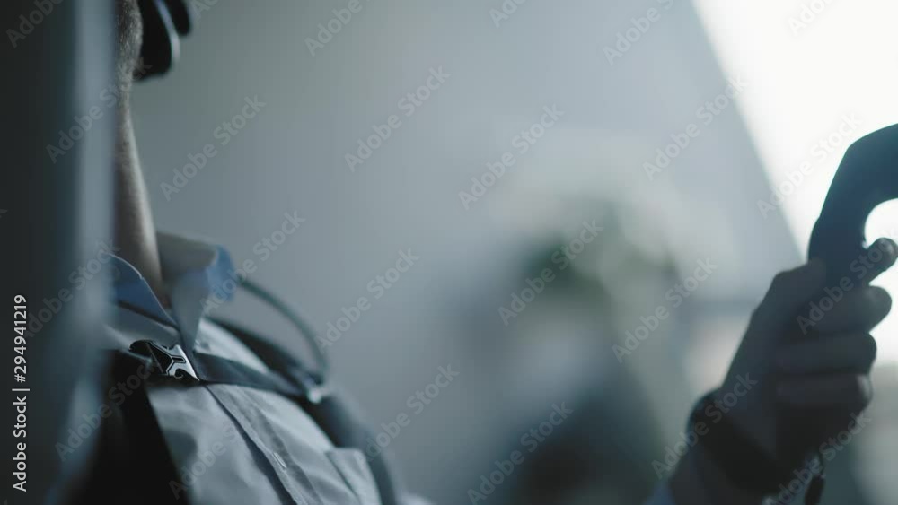 Hands of the man holds VR remote controller, isolated on light background. Wireless joystick for next generation video games and consoles. Man plays the game with VR devices Hands of the man holds VR remote controller, isolated on light background. Wireless joystick for next generation video games and consoles. Man plays the game with VR devices