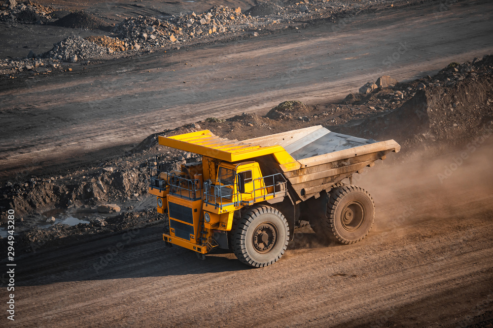 Big yellow mining truck laden anthracite moves open pit coal mine