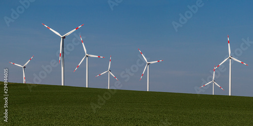 Panorama from a big Wind farm on green meadow iRenewable energy on green meadow in front of blue skyn front of blue sky photo