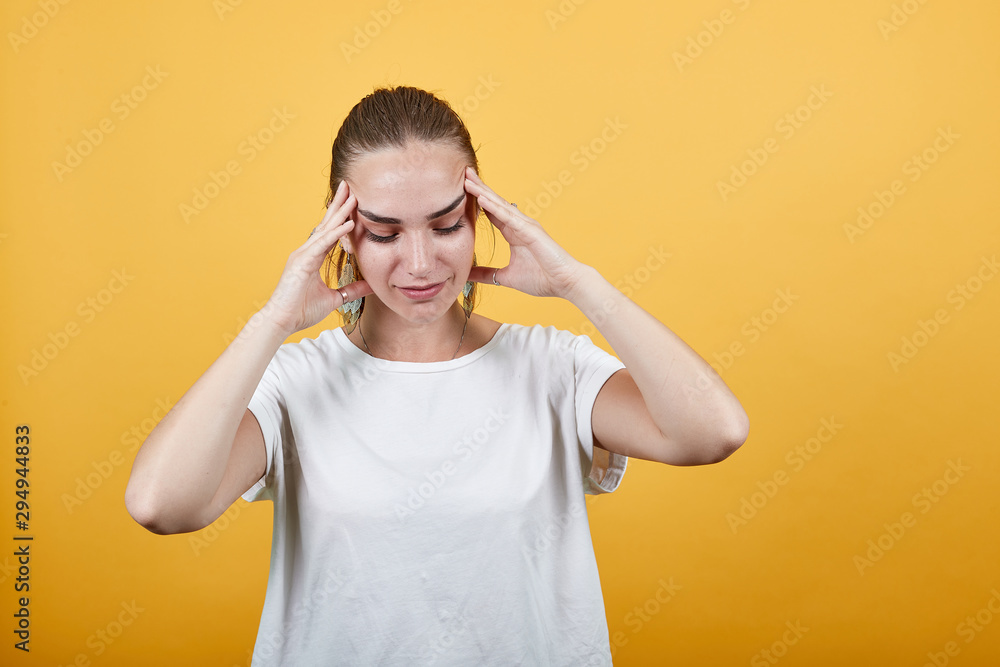 Woman in picture is shown depressed. Stuck between thoughts putting her hands trying to relief the pain to think peacefully without being overwhelmed by negative thinking focusing on calmness Woman in picture is shown depressed. Stuck between thoughts putting her hands trying to relief the pain to think peacefully without being overwhelmed by negative thinking focusing on calmness
