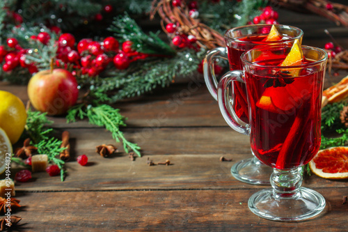 Christmas mulled wine on a wooden table. Traditional hot drink at Christmas (red wine with spices, New Year's Eve, Noel holiday festive) x-mas flat lay. food background. copy space. Top viev