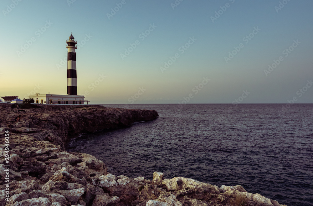 Φωτογραφία Blue hour view of the Cap Artrutx Lighthouse or Artrutx Lighthouse, an active 19th century lighthouse located on the low-lying headland of the same name on the Spanish island of Menorca
