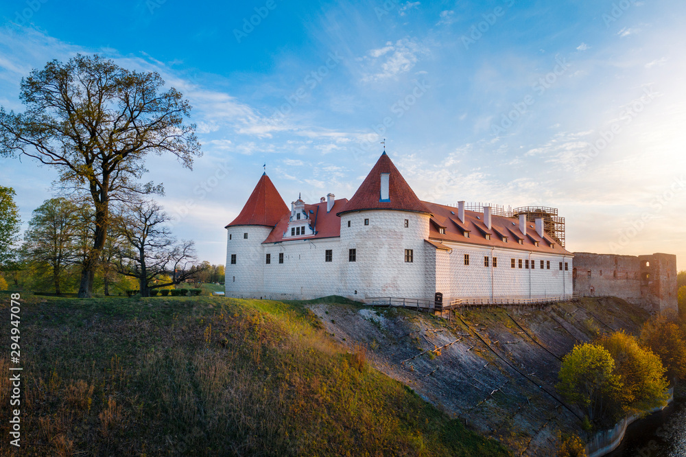Bauska town aerial panorama with Bauska medieval castle in sunset.