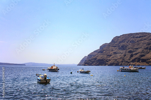 Boats moored along the coast of the Greek island of Thirassia photo