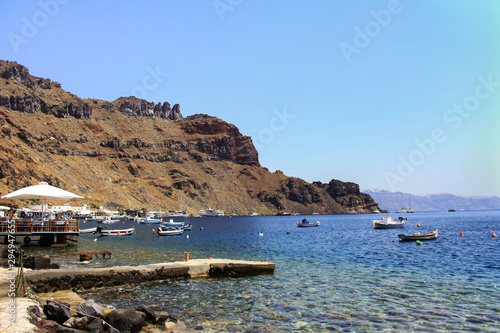 Boats moored along the coast of the Greek island of Thirassia photo