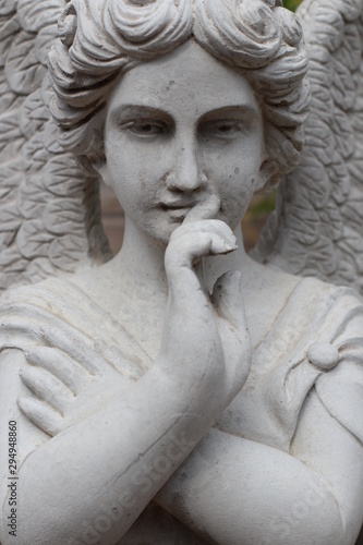 statue of an angel appearing to be thinking