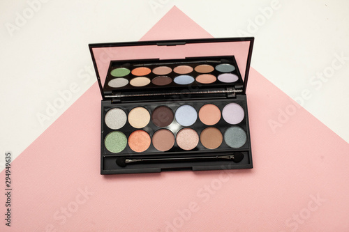 Set of pastel eyeshadows isolated. Eye shadow on white and pink background