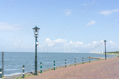 'IJsselmeer' (lake IJssel) with the beach and windmils at the city of URK, NLD