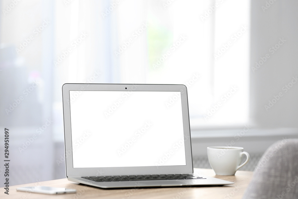 Fototapeta premium Modern laptop on desk in room. Home workplace