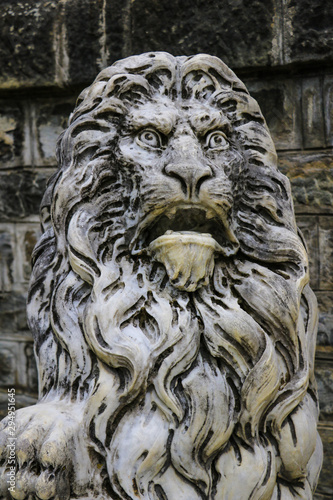 Sinaia, Romania, May 17, 2019: Marble sculpture. White stone lion. Architecture of the Middle Ages. European monuments. An ancient attraction. © Dzmitry