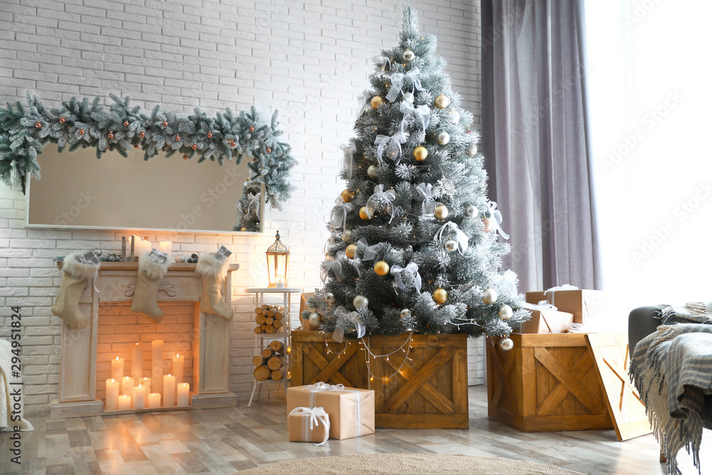 Stylish interior with decorated Christmas tree in living room - obrazy, fototapety, plakaty 