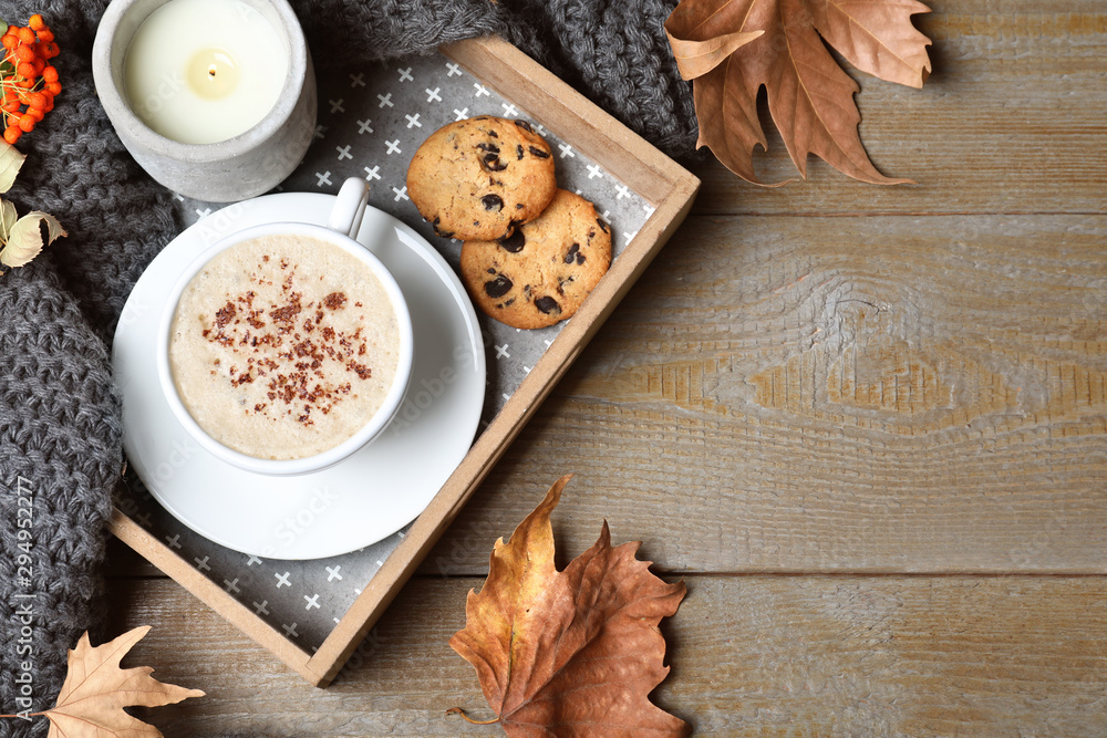 Flat lay composition with cup of hot drink on wooden table, space for text. Cozy autumn atmosphere Flat lay composition with cup of hot drink on wooden table, space for text. Cozy autumn atmosphere