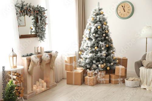 Stylish Christmas interior with beautiful decorated tree and fireplace © New Africa