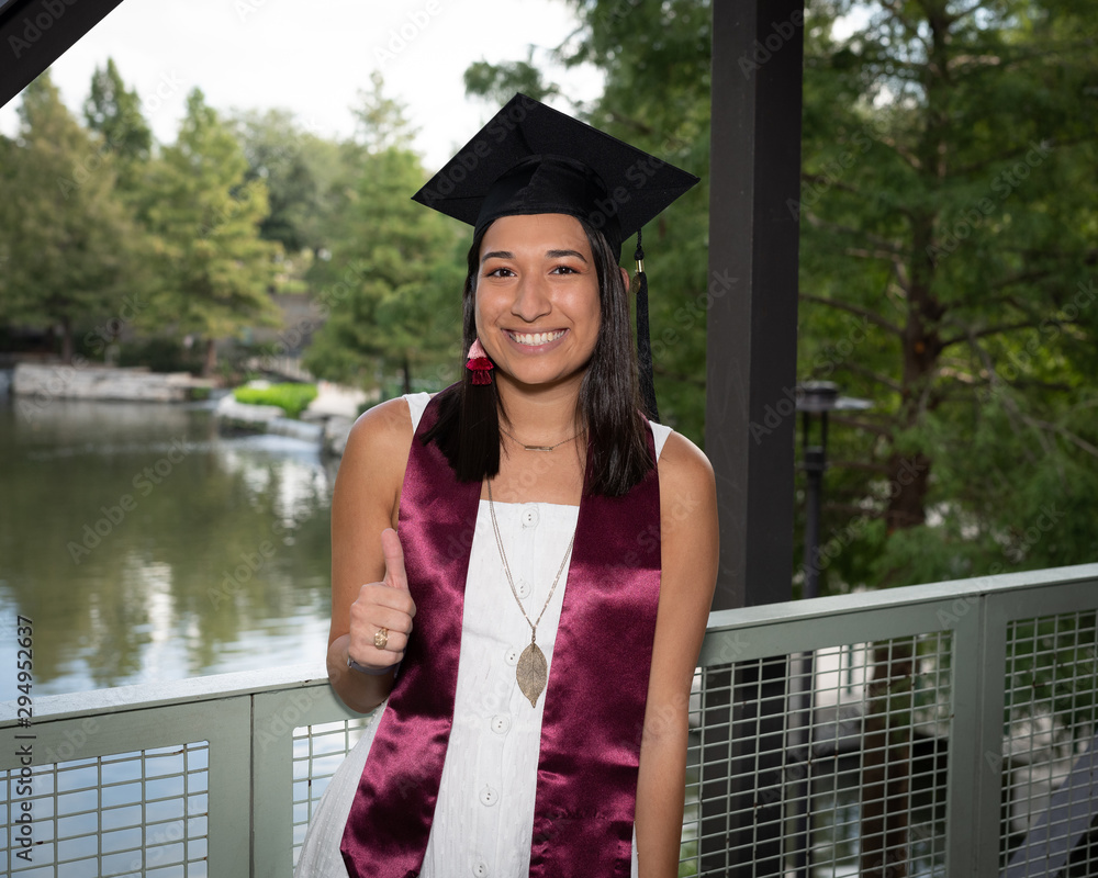 © Joe - Young beautiful college girl graduating in her cap and gown © Joe - Young beautiful college girl graduating in her cap and gown