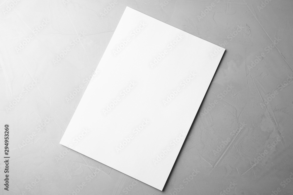 Blank paper sheet on light grey stone background, top view. Mock up for design Blank paper sheet on light grey stone background, top view. Mock up for design