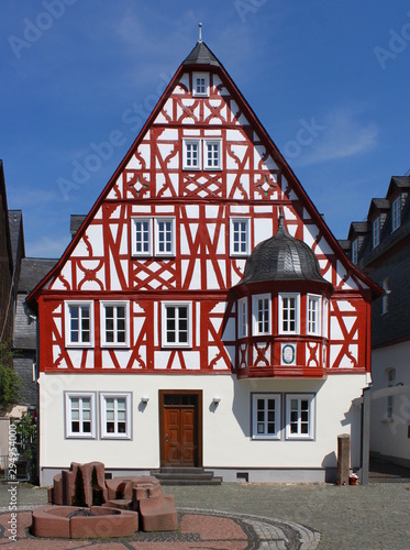 A half-timbered front-gabled residential house with an oriel window in the old town of Kirchberg, Germany photo