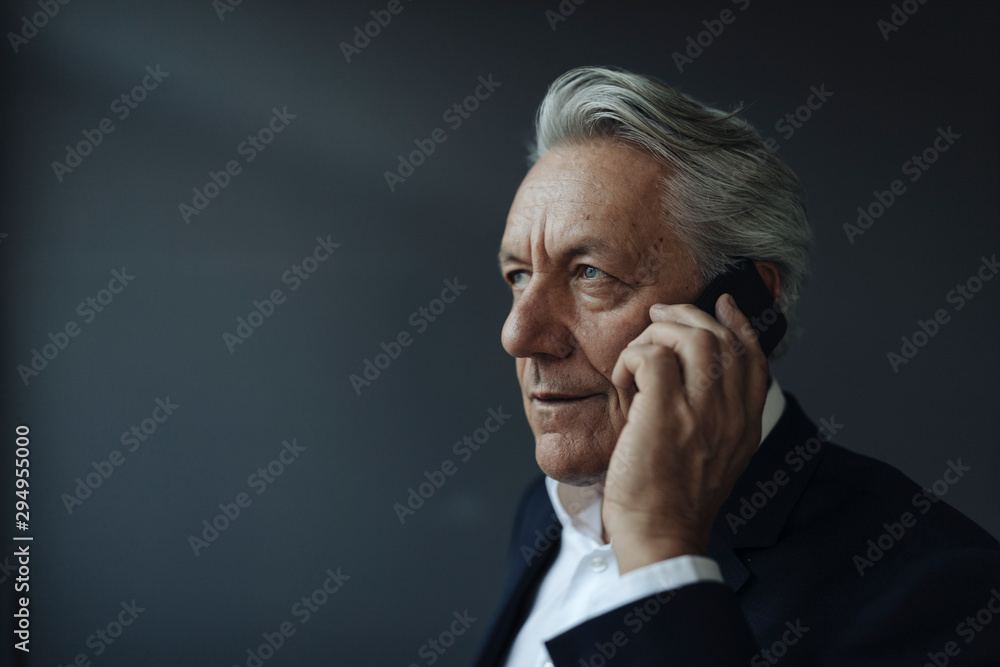 Portrait of a senior businessman talking on cell phone Portrait of a senior businessman talking on cell phone