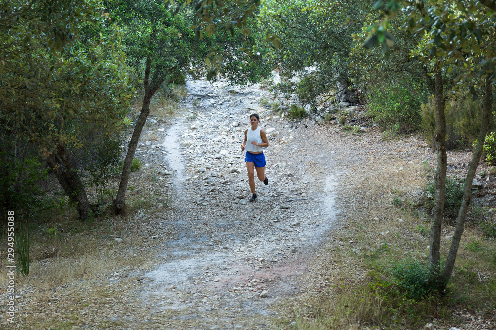 Young Asian jogger on a forest path Young Asian jogger on a forest path