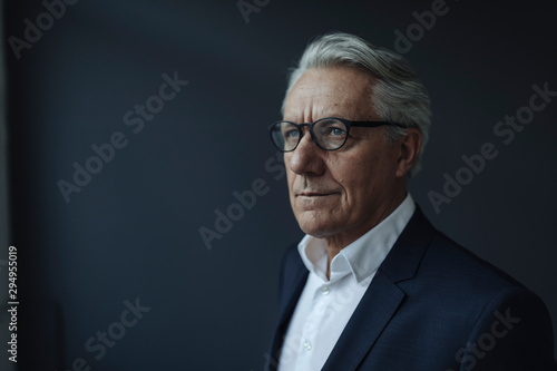 Portrait of a senior businessman looking away photo