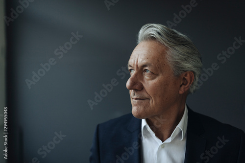 Close up of thoughtful businessman sitting indoors photo
