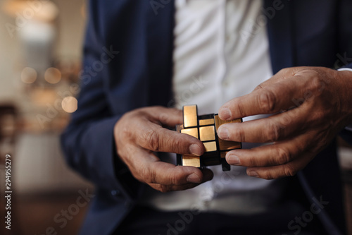 Close-up of businessman with Rubik's Cube photo