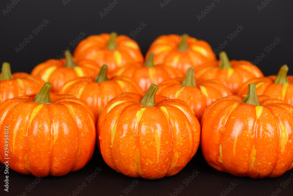 The orange pumpkins on black background
