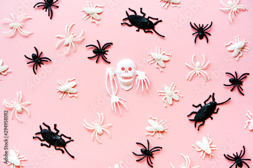 Creative Halloween Day composition. Holiday celebration sckeleton, spiders, flies, beetle. Pink paper background. Template greeting card design social media. Flat lay top view layout © Svetlana
