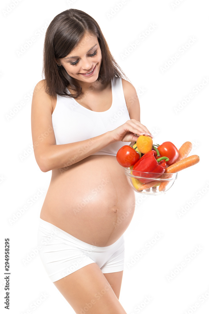 Pregnancy. Young, pregnant woman, on isolated white background holding fruits and vegetables Pregnancy. Young, pregnant woman, on isolated white background holding fruits and vegetables