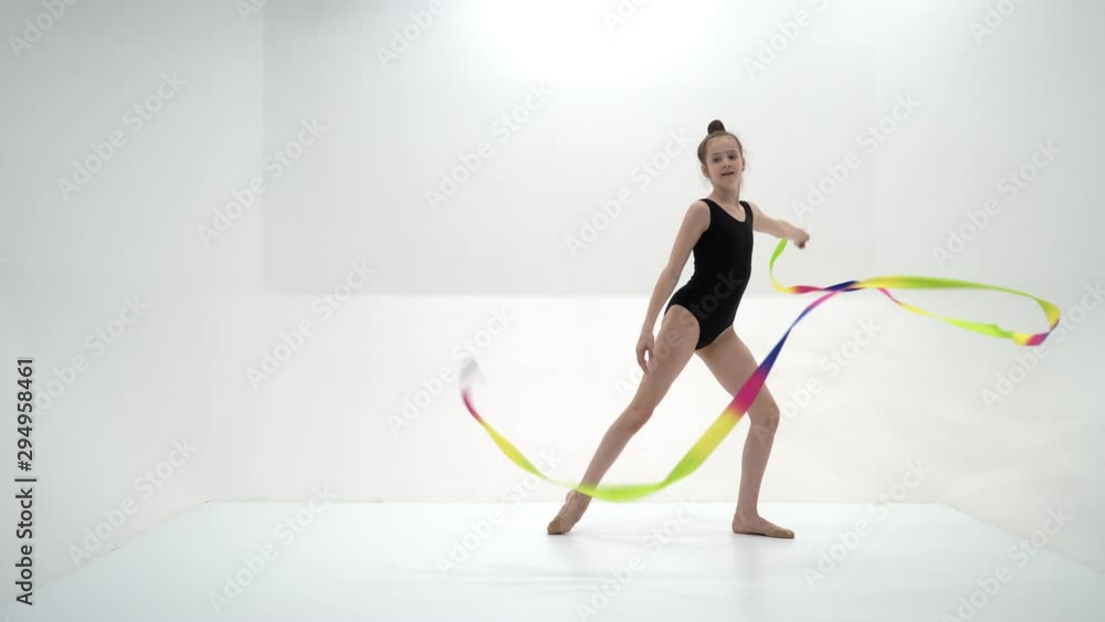 A girl gymnast performs exercises with a mace. A girl gymnast performs exercises with a mace.