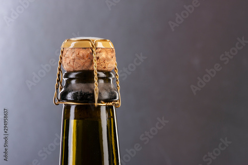 Closeup of champagne bottle and cork. plaque, muzzle