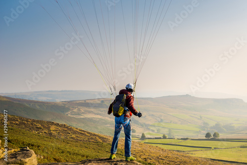 A man paragliding over the Stanage Edge in Derbyshire.