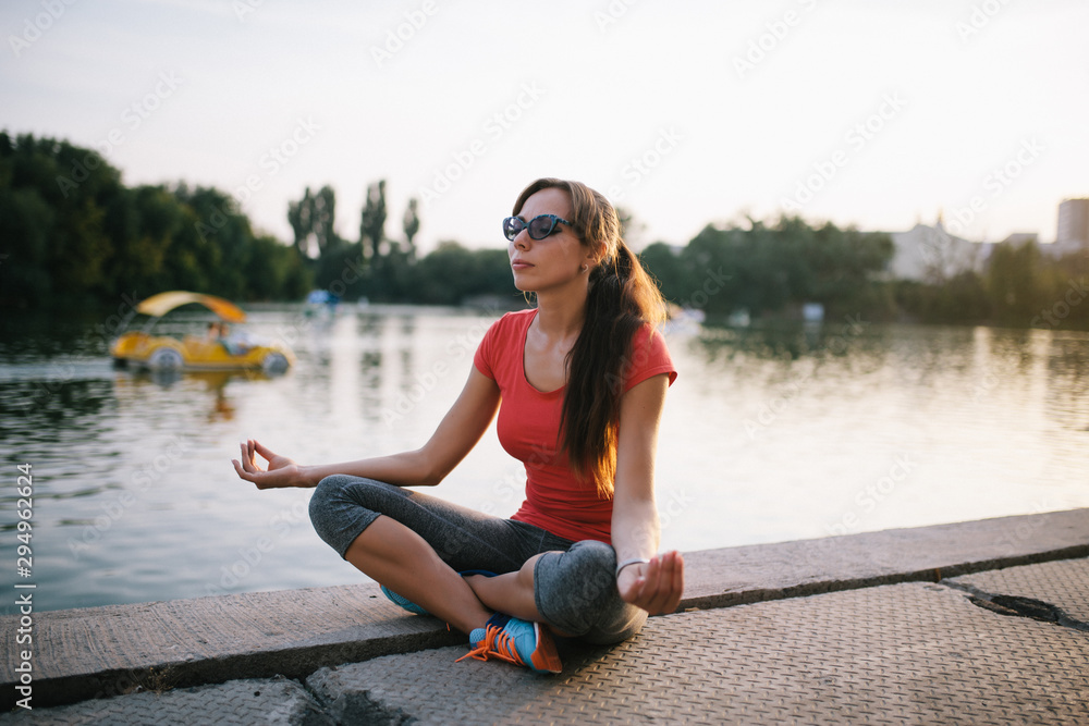 Young beautiful woman practicing yoga outdoor. Relax