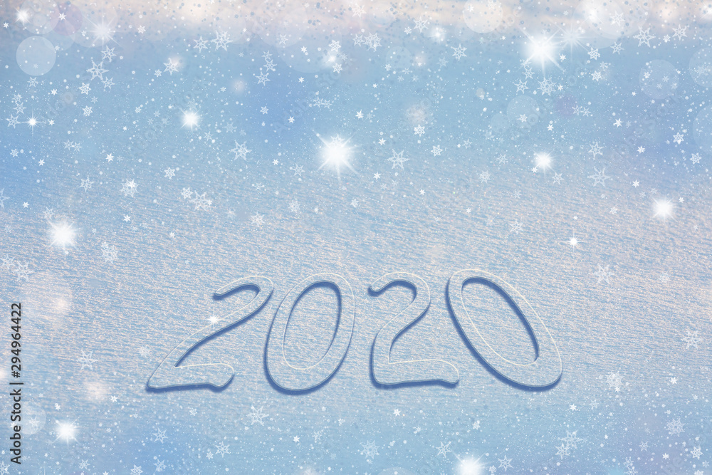 Snowy numbers 2020 on a snowy surface against the backdrop of sparkling snowflakes, stars, and beautiful bokeh. Merry blue christmas background. Snowy numbers 2020 on a snowy surface against the backdrop of sparkling snowflakes, stars, and beautiful bokeh. Merry blue christmas background.