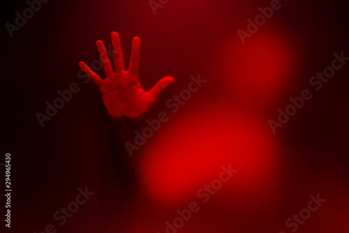Red color version of Creepy man holding the frosted glass with one hand.
