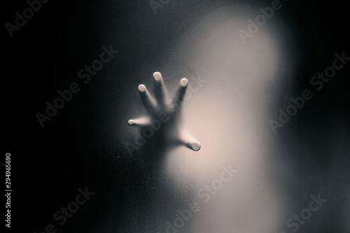 Tablou canvas Black color version of Creepy man holding the frosted glass with one hand