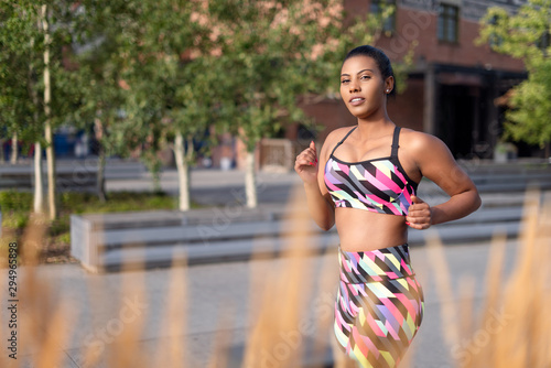Beautiful woman running, stretching and exercising in urban environment