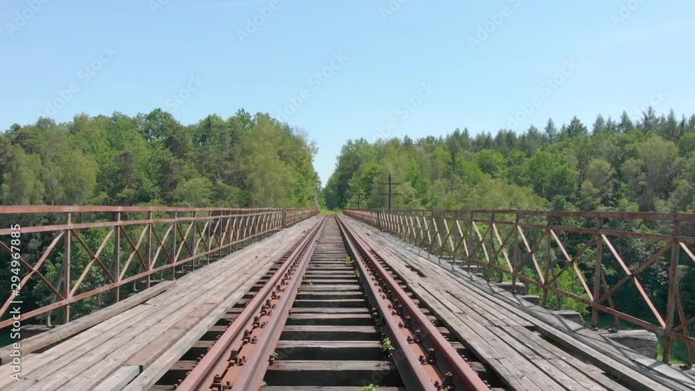 drone view of an old rusty railway bridge over the lake/river (aerial) drone view of an old rusty railway bridge over the lake/river (aerial)