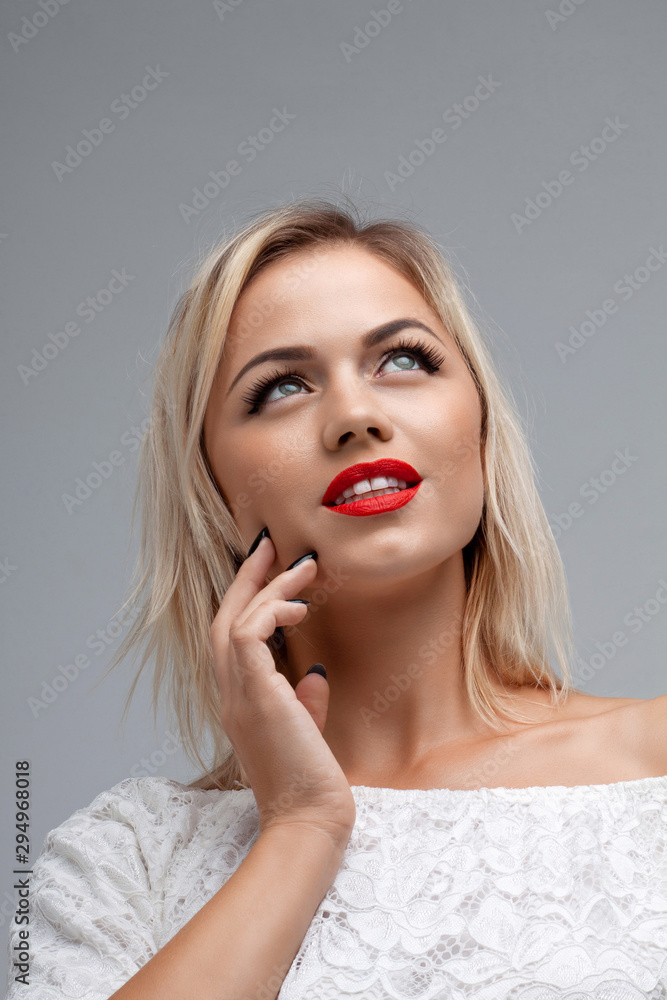 Attractive woman with red lips. Blonde girl in white clothes. Attractive woman with red lips. Blonde girl in white clothes.