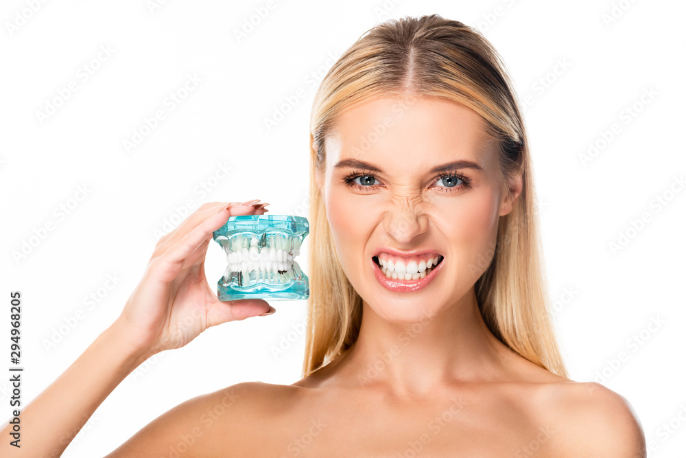 naked woman showing teeth and holding jaw model isolated on white naked woman showing teeth and holding jaw model isolated on white
