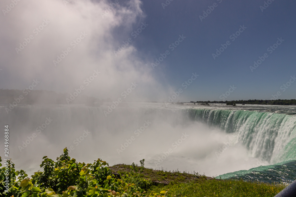Niagara Falls park and the mist from the fall Niagara Falls park and the mist from the fall