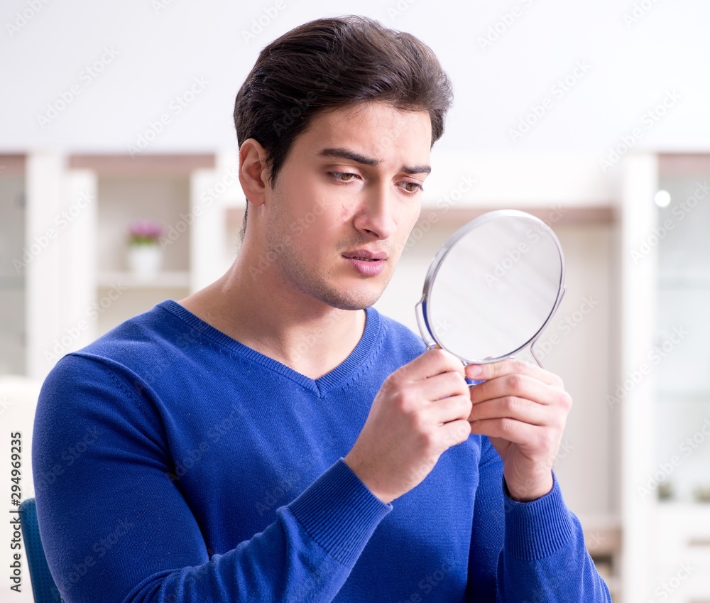 Man panicking because of pimples on the skin Man panicking because of pimples on the skin