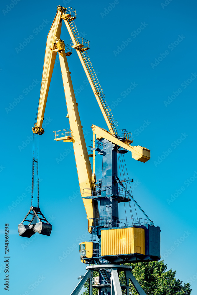Huge yellow metal cranes in the port. Huge yellow metal cranes in the port.