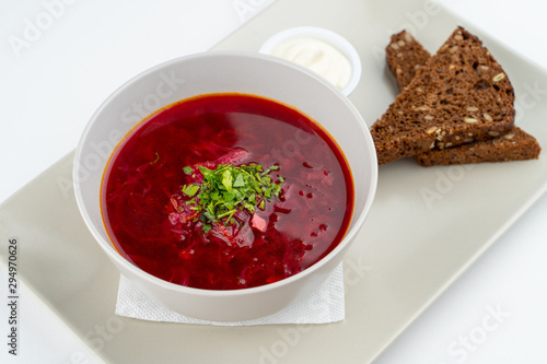 Classic russian beetroot soup: borscht with vegetables, garlic toasts and fresh sour cream